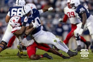 Nebraska Cornhusker linebacker Marques Watson-Trent (33) tackles Penn State Nittany Lion running back Nicholas Singleton (10) in the fourth quarter during a college football game on Saturday, Nov. 22, 2025, in State College, PA. Photo by John S. Peterson.