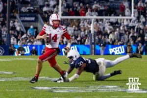 Nebraska Cornhusker quarterback TJ Lateef (14) scrambles with the ball against Penn State Nittany Lion defensive end Dani Dennis-Sutton (33) during a college football game on Saturday, Nov. 22, 2025, in State College, PA. Photo by John S. Peterson.