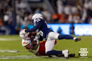 Nebraska Cornhusker running back Emmett Johnson (21) tackled by Penn State Nittany Lion safety King Mack (16) during a college football game on Saturday, Nov. 22, 2025, in State College, PA. Photo by John S. Peterson.