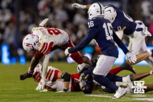 Nebraska Cornhusker running back Emmett Johnson (21) runs with the ball Penn State Nittany Lion safety King Mack (16) in the fourth quarter during a college football game on Saturday, Nov. 22, 2025, in State College, PA. Photo by John S. Peterson.