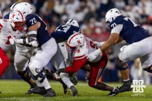 Nebraska Cornhusker linebacker Vincent Shavers Jr. (9) tackles Penn State Nittany Lion linebacker Tony Rojas (13) in the second quarter during a college football game on Saturday, Nov. 22, 2025, in State College, PA. Photo by John S. Peterson.