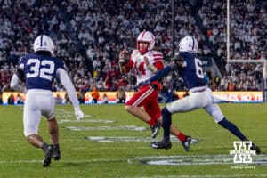 Nebraska Cornhusker quarterback TJ Lateef (14) scrambles with the ball against Penn State Nittany Lion safety Zakee Wheatley (6) and linebacker Keon Wylie (32) in the second quarter during a college football game on Saturday, Nov. 22, 2025, in State College, PA. Photo by John S. Peterson.