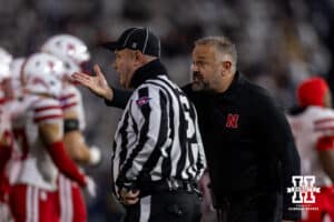 Nebraska Cornhusker head coach Matt Rhule reacts to play on the field with a referee against the Penn State Nittany Lions in the first quarter during a college football game on Saturday, Nov. 22, 2025, in State College, PA. Photo by John S. Peterson.