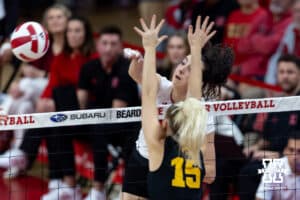 Nebraska Cornhusker opposite Virginia Adriano (9) spikes the ball against Iowa Hawkeye outside hitter Carmel Vares (15) in the third set during a college volleyball match on Thursday, Nov. 20, 2025, in Lincoln, Nebraska. Photo by John S. Peterson.