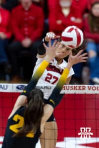 Nebraska Cornhusker outside hitter Harper Murray (27) spikes the ball against Iowa Hawkeye middle hitter Aleksandra Stojanovic (24) in the second set during a college volleyball match on Thursday, Nov. 20, 2025, in Lincoln, Nebraska. Photo by John S. Peterson.