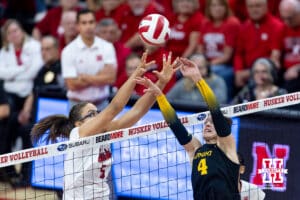 Nebraska Cornhusker middle blocker Rebekah Allick (5) battles for the ball against Iowa Hawkeye setter Claire Ammeraal (4) in the first set during a college volleyball match on Thursday, Nov. 20, 2025, in Lincoln, Nebraska. Photo by John S. Peterson.