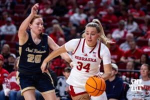 Nebraska Cornhusker forward Emily Fisher (34) drives to the basket against Oral Roberts Golden Eagle guard Bella Edwards (20) in the fourth quarter during a college basketball game on Wednesday, Nov. 19, 2025, in Lincoln, Nebraska. Photo by John S. Peterson.