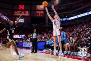 Nebraska Cornhusker guard Claire Johnson (5) makes a three-point shot against Oral Roberts Golden Eagle guard Ari Gordon (0) during a college basketball game on Wednesday, Nov. 19, 2025, in Lincoln, Nebraska. Photo by John S. Peterson.