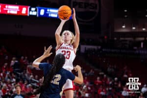 Nebraska Cornhusker guard Britt Prince (23) makes a three-point shot against Oral Roberts Golden Eagle forward A'Maya Holton (22) in the first quarter during a college basketball game on Wednesday, Nov. 19, 2025, in Lincoln, Nebraska. Photo by John S. Peterson.