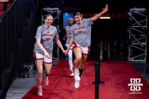Nebraska Cornhuskers Petra Bozan and Logan Nissley are skipping and holding hands as they make their way to the court to get ready for Oral Roberts Golden Eagles during a college basketball game on Wednesday, Nov. 19, 2025, in Lincoln, Nebraska. Photo by John S. Peterson.