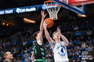Creighton Bluejay Josh Dix (4) looks to make a layup over Garrett Anderson (16) during a basketball game against North Dakota on Wednesday, Nov 19, 2025, in Omaha, Nebraska. Photo by Brandon Tiedemann.