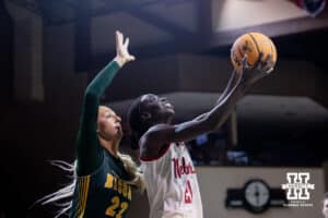 Nebraska Cornhusker forward Eliza Maupin (21) makes a lay up against North Dakota State Bison forward Avery Koenen (22) during a college basketball game on Sunday, Nov 16, 2025, in Sioux Falls, South Dakota. Photo by John S. Peterson.