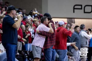 Nebraska Cornhusker fans hug from all the excitement during a college men’s basketball game against the Oklahoma Sooners on Saturday, Nov 15, 2025, in Sioux Falls, South Dakota. Photo by John S. Peterson.