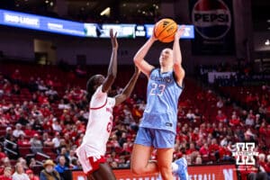 Creighton Bluejay guard Neleigh Gessert (23) makes a lay up against Nebraska Cornhusker forward Eliza Maupin (21) during a college women’s basketball game on Wednesday, Nov. 12, 2025, in Lincoln, Nebraska. Photo by John S. Peterson.