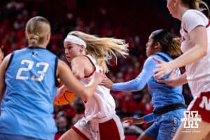 Nebraska Cornhusker guard Britt Prince (23) drive to the basket against Creighton Bluejay guard Neleigh Gessert (23) and Kiani Lockett (11) during a college women’s basketball game on Wednesday, Nov. 12, 2025, in Lincoln, Nebraska. Photo by John S. Peterson.