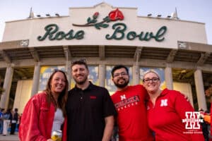 Nebraska Cornhusker fans pose for a photo in front of a stadium before a college football game against the UCLA Bruins on Saturday, November 8, 2025, in Pasadena, California. Photo by John S. Peterson.