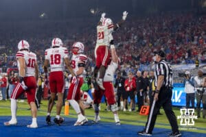 Nebraska Cornhusker running back Emmett Johnson (21) is being lifted by Rocco Spindler after scoring a touchdown against the UCLA Bruins in the third quarter during a college football game on Saturday, November 8, 2025, in Pasadena, California. Photo by John S. Peterson.