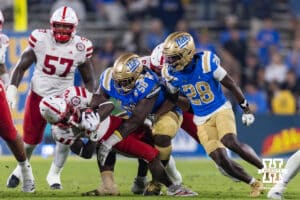 Nebraska Cornhusker running back Emmett Johnson (21) tackled by UCLA Bruin defensive lineman Gary Smith III (58) in the third quarter during a college football game on Saturday, November 8, 2025, in Pasadena, California. Photo by John S. Peterson.