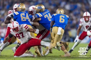 UCLA Bruin running back Anthony Woods (6) is stopped by Nebraska Cornhusker defensive lineman Keona Davis (97) in the first quarter during a college football game on Saturday, November 8, 2025, in Pasadena, California. Photo by John S. Peterson.