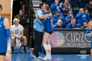 Creighton Bluejay Annalea Maeder #17 hugs head coach Brian Rosen during a volleyball game against Georgetown on Sunday, November 9, 2025, in Omaha, Nebraska. Photo by Brandon Tiedemann.