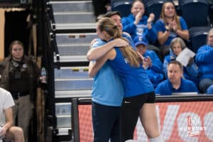 Creighton Bluejay Kiara Reinhardt #5 hugs head coach Brian Rosen during a volleyball game against Georgetown on Sunday, November 9, 2025, in Omaha, Nebraska. Photo by Brandon Tiedemann.