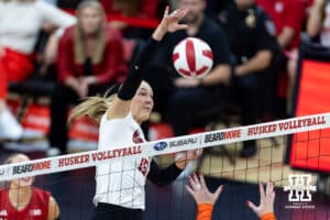 Nebraska Cornhusker middle blocker Andi Jackson (15) spikes the ball against the Illinois Fighting Illini in the third set during a college volleyball match on Thursday, November 6, 2025, in Lincoln, Nebraska. Photo by John S. Peterson.