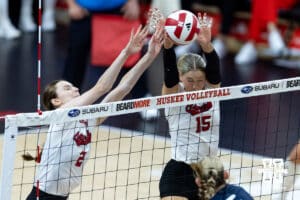 Nebraska Cornhusker setter Bergen Reilly (2) and middle blocker Andi Jackson (15) blocks the ball Illinois Fighting Illini outside hitter Taylor de Boer (5) in the third set during a college volleyball match on Thursday, November 6, 2025, in Lincoln, Nebraska. Photo by John S. Peterson.