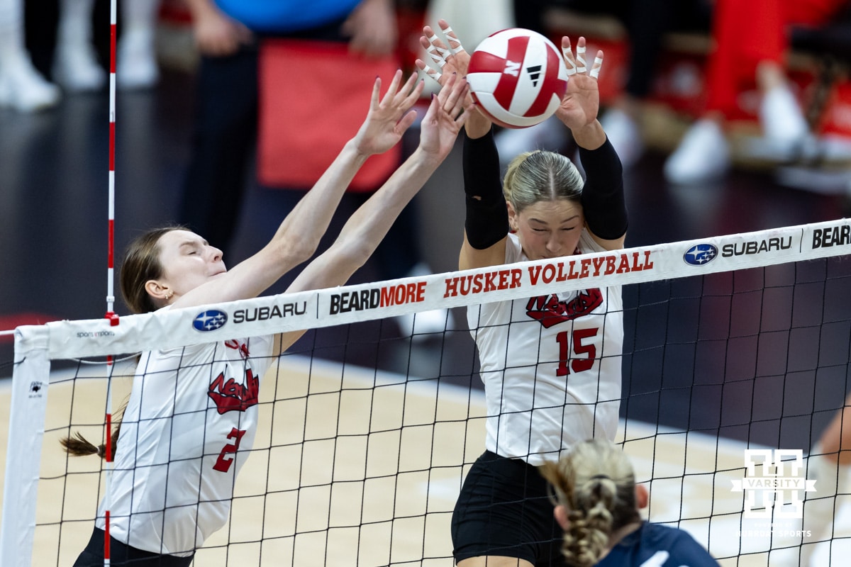 Nebraska Cornhusker setter Bergen Reilly (2) and middle blocker Andi Jackson (15) blocks the ball Illinois Fighting Illini outside hitter Taylor de Boer (5) in the third set during a college volleyball match on Thursday, November 6, 2025, in Lincoln, Nebraska. Photo by John S. Peterson.