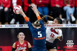 Nebraska Cornhusker outside hitter Taylor Landfair (12) spikes the ball against Illinois Fighting Illini outside hitter Taylor de Boer (5) in the third set during a college volleyball match on Thursday, November 6, 2025, in Lincoln, Nebraska. Photo by John S. Peterson.