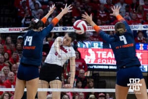 Nebraska Cornhusker opposite Virginia Adriano (9) spikes the ball against Illinois Fighting Illini outside hitter Alyssa Aguayo (19) and middle blocker Kayla Burbage (9) in the second set during a college volleyball match on Thursday, November 6, 2025, in Lincoln, Nebraska. Photo by John S. Peterson.