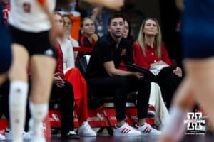 Nebraska Cornhusker interium assistant coach Brennan Hagar watches the action on the court against the Illinois Fighting Illini during a college volleyball match on Thursday, November 6, 2025, in Lincoln, Nebraska. Photo by John S. Peterson.