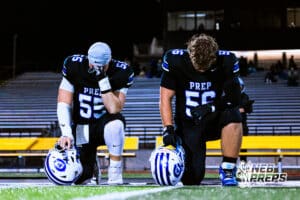 Creighton Preps Jake Brock (55) and Gavin Trapp (56) are praying before a high school football game against Lincoln Southeast on Friday, October 31, 2025 in Omaha, Nebraska. Photo By Jack Stephens.