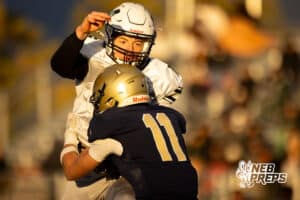 Millard West quarterback Gus Dahlhauser (16) is hit while he passes by Elkhorn South Isaac Pemberton (11) during a high school football game, Friday, October 31, 2025, Omaha, Nebraska. Photo by Braden Cochran.
