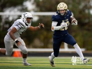 Elkhorn South running back Joey Kiscoan (20) evades a Millard West tackler during a high school football game, Friday, October 31, 2025, Omaha, Nebraska. Photo by Braden Cochran.