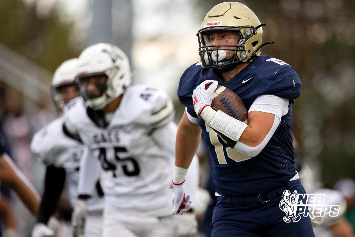 Elkhorn South Jaydon Sutko (19) races past Millard West defenders during a high school football game, Friday, October 31, 2025, Omaha, Nebraska. Photo by Braden Cochran.