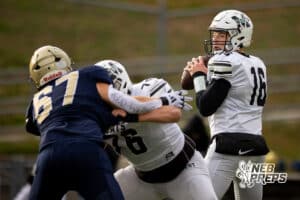 Millard West quarterback Gus Dahlhauser (16) looks for a target to pass to during a high school football game, Friday, October 31, 2025, Omaha, Nebraska. Photo by Braden Cochran.