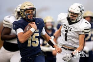 Elkhorn South quarterback Charlie Buller (15) moves past wildcats defenders during a high school football game, Friday, October 31, 2025, Omaha, Nebraska. Photo by Braden Cochran.