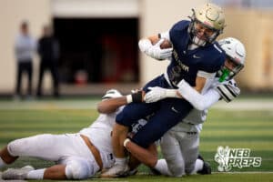 Elkhorn South wide receiver Cameron Wolf (1) is brought down by two Millard West defenders during a high school football game, Friday, October 31, 2025, Omaha, Nebraska. Photo by Braden Cochran.