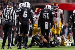 Nebraska Cornhusker quarterback Dylan Raiola (15) on the turf holding his leg after being sacked in the third quarter against the Southern California Trojans during a college football game on Saturday, November 1, 2025, in Lincoln, Nebraska. Photo by John S. Peterson.