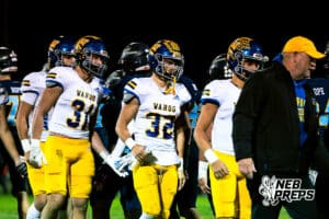 Wahoo's Kip Brigham (32) in a high five line after winning a high school football game at Concordia on Friday, October 24, 2025 in Omaha, Nebraska. Photo By Jack Stephens.
