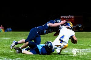 ahoo's Jase Kaminski (4) is getting sacked by a band of mustangs during a high school football game at Concordia on Friday, October 24, 2025 in Omaha, Nebraska. Photo By Jack Stephens.