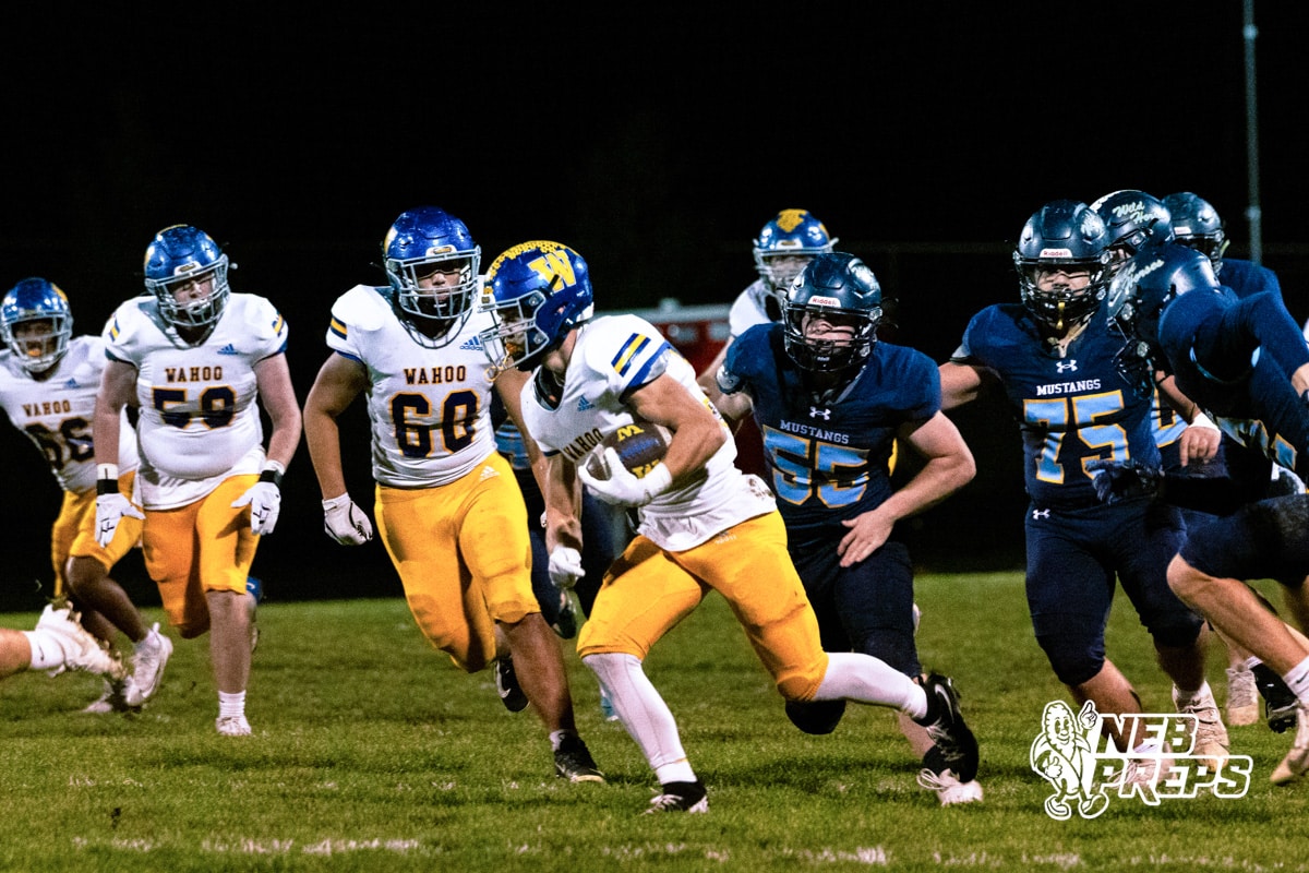 Wahoo's Kip Brigham (32) running through traffic to score a rushing touchdown during a high school football game at Concordia on Friday, October 24, 2025 in Omaha, Nebraska. Photo By Jack Stephens.