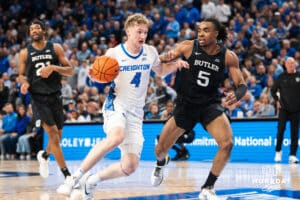 Creighton Bluejay Josh Dix (4) drives past Michael Ajayi (5) during a basketball game against Butler on Tuesday, Dec 30, 2025, in Omaha, Nebraska. Photo by Brandon Tiedemann.