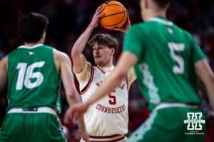 Nebraska Cornhusker forward Braden Frager (5) looks for the pass against North Dakota Fighting Hawk guard Garrett Anderson (16) and forward Matthew Bothun (5) in the second half during a college basketball game on Sunday, Dec. 21, 2025, in Lincoln, Nebraska. Photo by John S. Peterson.