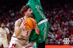 Nebraska Cornhusker guard Sam Hoiberg (1) drives into North Dakota Fighting Hawk forward Marley Curtis (0) going for a lay up in the second half during a college basketball game on Sunday, Dec. 21, 2025, in Lincoln, Nebraska. Photo by John S. Peterson.