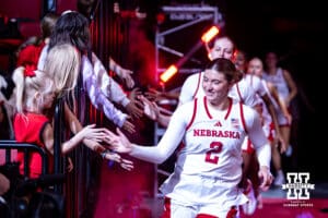 Nebraska Cornhusker guard Logan Nissley (2) gives five to a Husker fan running out to the court against the California Baptist Lancers during a college basketball game on Sunday, Dec. 21, 2025, in Lincoln, Nebraska. Photo by John S. Peterson.