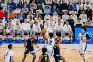 Creighton's Blake Harper makes a pass to Josh Dix. Creighton men's basketball hosts Marquette at CHI Health Center on Saturday, Dec 20, 2025, in Omaha, Nebraska. Photo by Kyle Byers.