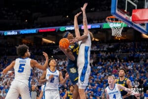 Creighton's Owen Freeman defends against a lay up attempt by Marquette's Chase Ross. Creighton men's basketball hosts Marquette at CHI Health Center on Saturday, Dec 20, 2025, in Omaha, Nebraska. Photo by Kyle Byers.