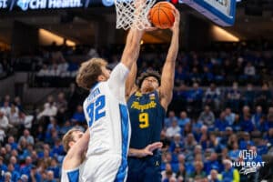 Creighton's Owen Freeman defends against a dunk attempt by Marquette's Damarius Owens. Creighton men's basketball hosts Marquette at CHI Health Center on Saturday, Dec 20, 2025, in Omaha, Nebraska. Photo by Kyle Byers.
