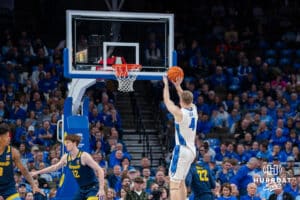 Creighton's Josh Dix attempts a three-point shot. Creighton men's basketball hosts Marquette at CHI Health Center on Saturday, Dec 20, 2025, in Omaha, Nebraska. Photo by Kyle Byers.